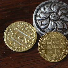 Die Abbildung zeigt drei verschiedene Münzen aus Nepal.